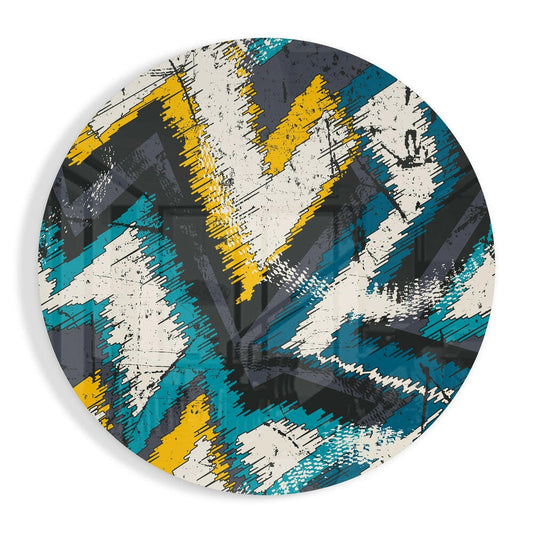 Circular glass wall art with diagonal brushstroke pattern in teal, yellow, cream, and charcoal, viewed from front.