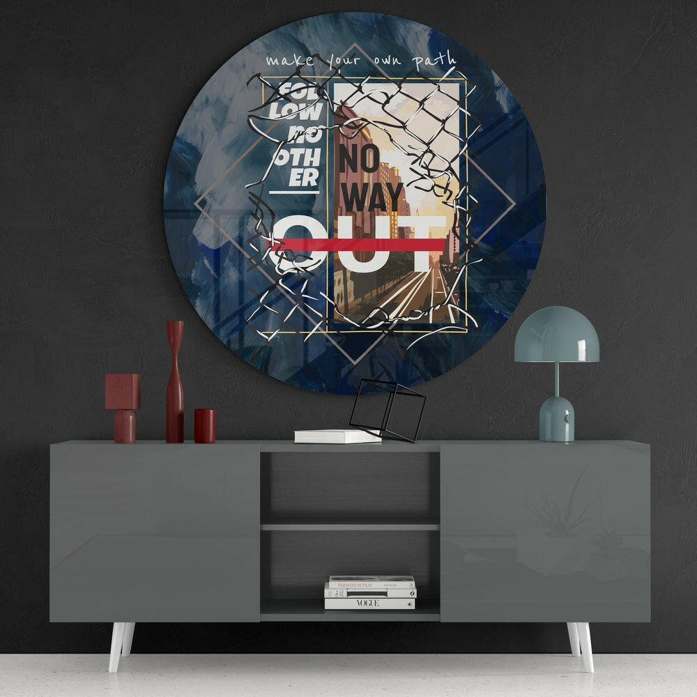 Round glass wall art with blue tones, geometric overlays, and "make your own path" text displayed above gray console table with red decorative objects.