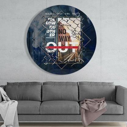 Round blue glass wall art with geometric patterns, "make your own path" text, and "no way" signage, displayed above a gray sofa.