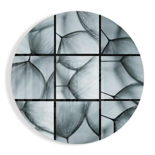 Circular glass wall art with dandelion seed heads in grayscale, divided into nine grid sections by black lines.