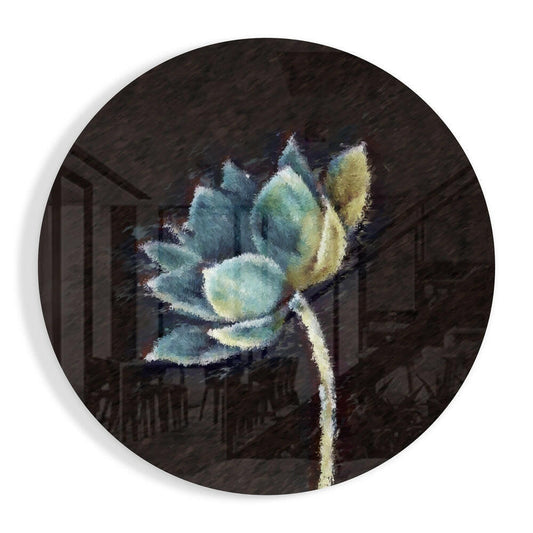 Circular glass wall art featuring a painted teal and cream lotus flower with stem against dark architectural background.
