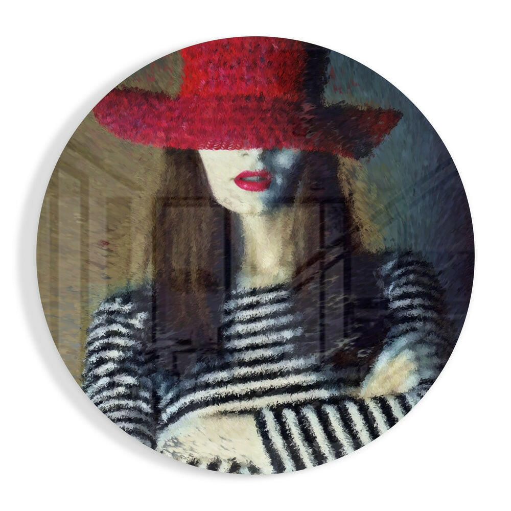 Circular glass wall art featuring a woman wearing a bold red hat and striped black-and-white gloves against a muted background.