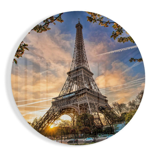 Round glass wall art featuring the Eiffel Tower at sunset with autumn foliage, golden sky, and street-level perspective.