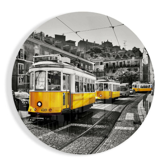 Yellow trams lined on wet cobblestone street with historic European buildings in black and white selective color background.