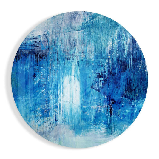 Circular glass wall art with layered blue and white brushstrokes creating vertical streaks and textured patterns throughout.