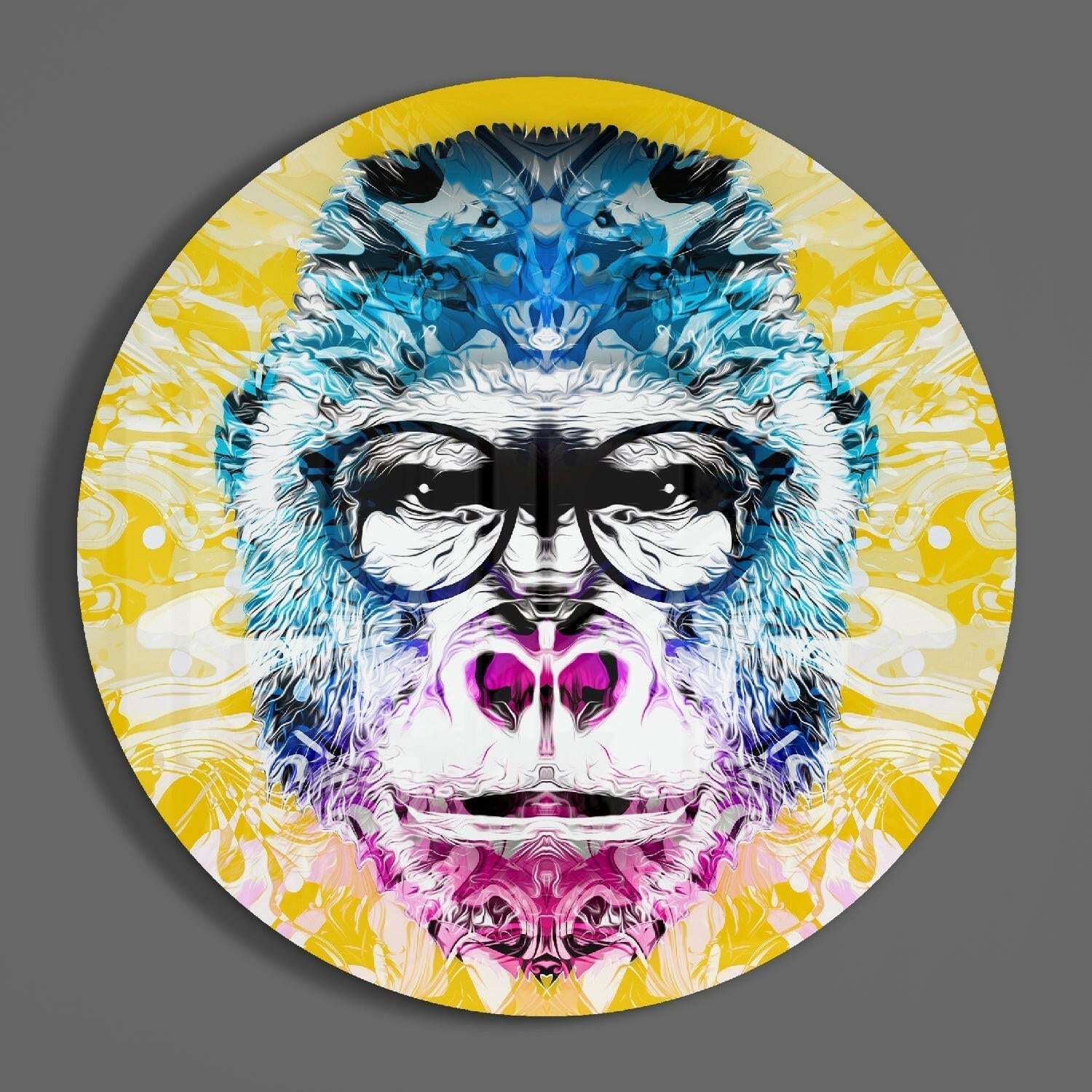 Circular glass wall art featuring a stylized gorilla face with blue markings, pink mouth, black sunglasses, and yellow radiating background pattern.