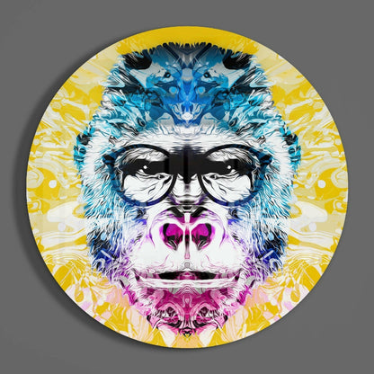 Circular glass wall art featuring a stylized gorilla face with blue markings, pink mouth, black sunglasses, and yellow radiating background pattern.