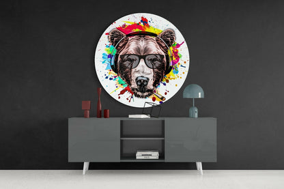 Circular glass wall art featuring a colorful splatter-painted bear wearing sunglasses and headphones above a gray console table.