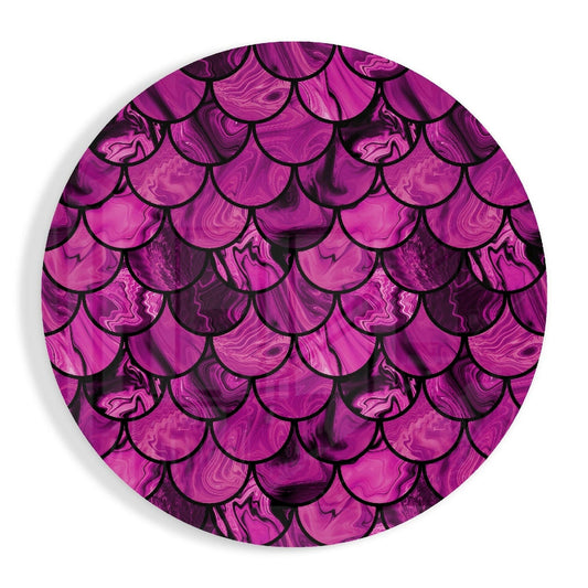 Circular glass wall art displaying overlapping magenta and purple marble-textured fish scales with black outline details, viewed straight on.