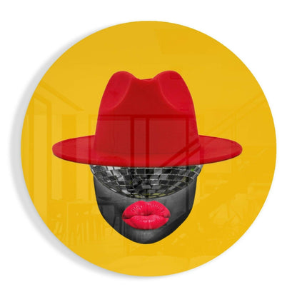 Front view of circular yellow glass wall art featuring a stylized face with black skin, red lips, and red cowboy hat.