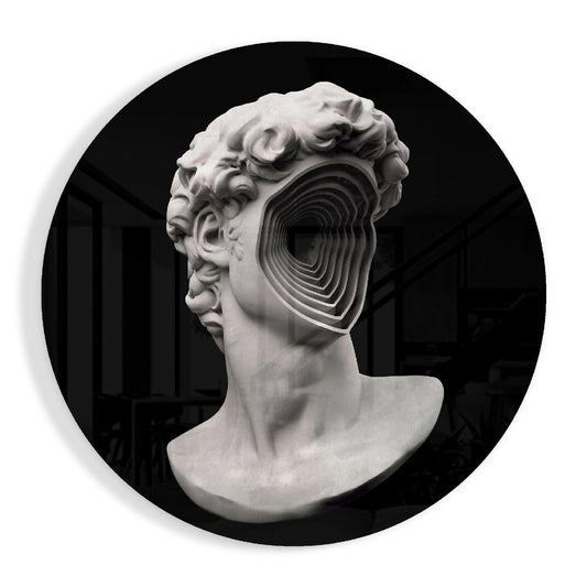 White plaster classical bust in profile with concentric rectangular spiral carved through one eye socket against black circular background.