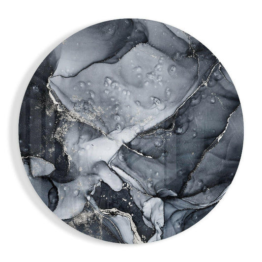 Overhead view of circular charcoal silver ink marble glass wall art with swirling black and white patterns and crystalline accents.