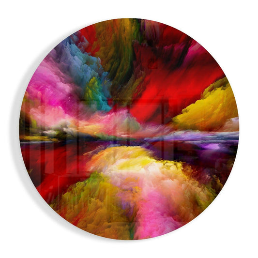 Circular glass wall art featuring a surreal landscape with dramatic swirling clouds in magenta, red, yellow, and blue tones reflected in water below.