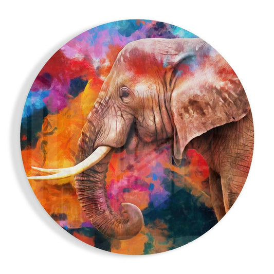 Circular glass wall art featuring a detailed elephant with ivory tusks against a vibrant, multicolored abstract background of reds, oranges, blues, and purples.