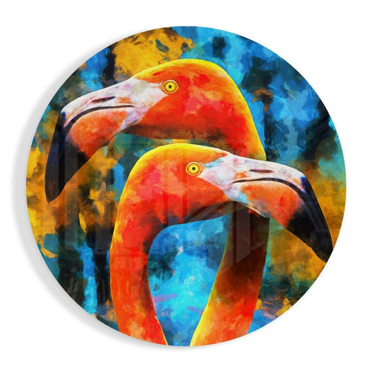 Two vibrant orange flamingos with white heads and yellow eyes depicted on a circular blue and gold glass wall art piece.