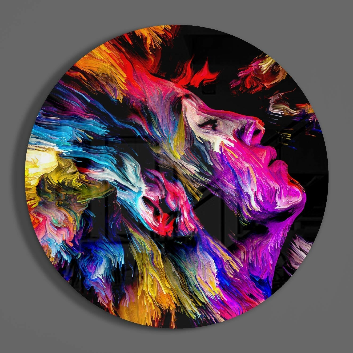 Circular glass wall art featuring vibrant abstract swirled patterns in magenta, purple, blue, yellow, and orange against black background.