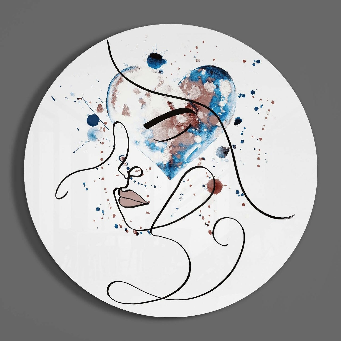 Circular glass wall art featuring minimalist line-drawn profile with blue and brown watercolor splashes on white background.