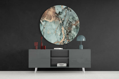 Round turquoise marble glass wall art displayed above gray sideboard with red candles and teal lamp against dark wall.