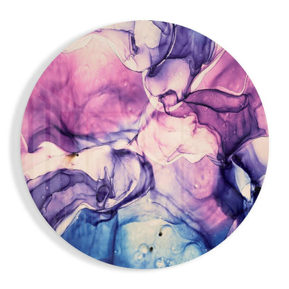 Circular glass wall art with swirled pink, purple, and blue marbled patterns, overhead view showing fluid color gradients and translucent effects.