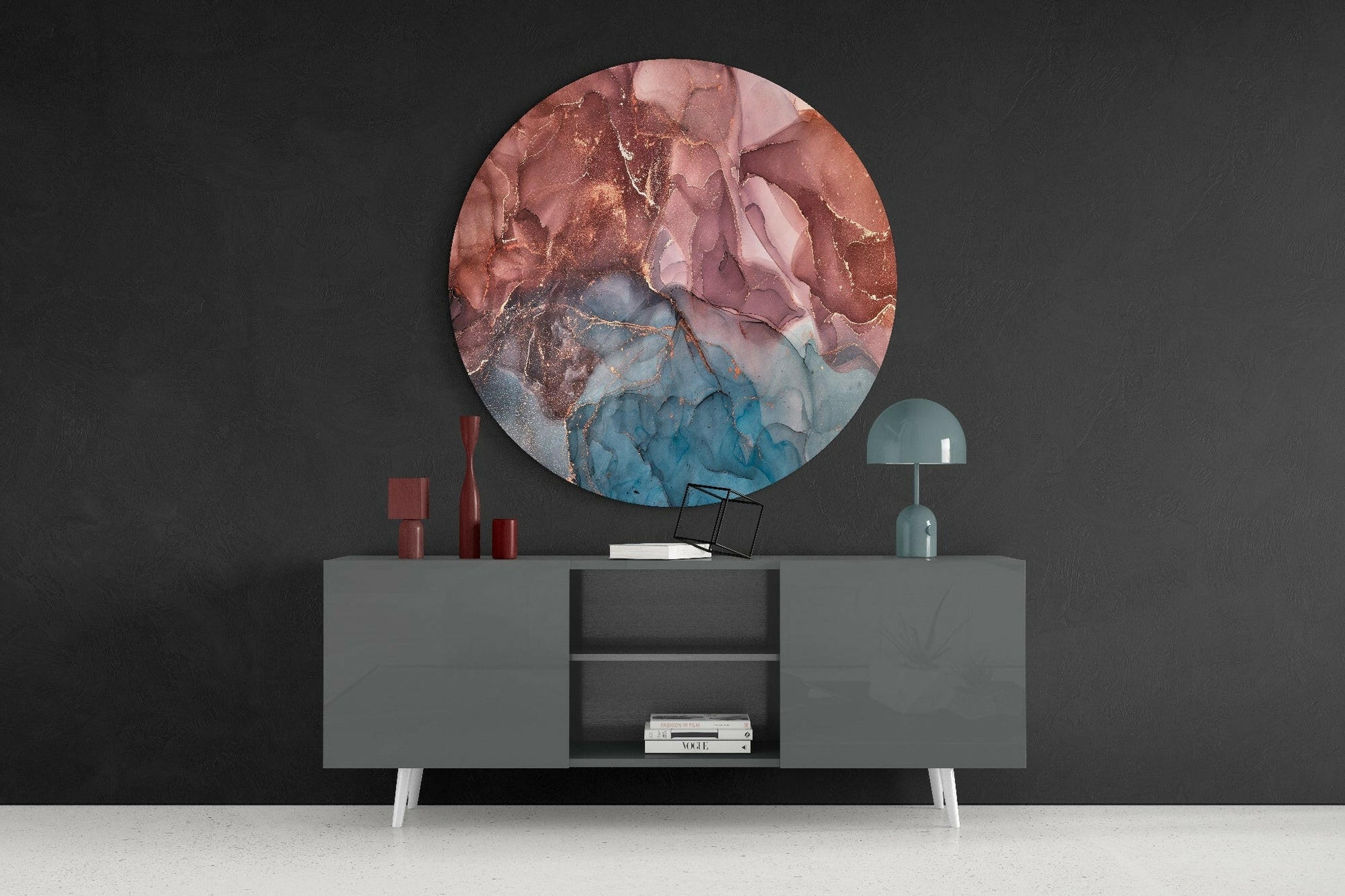 Round orange and blue marble glass wall art displayed above a gray console table with red candles and a mint lamp.