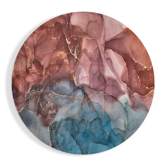 Circular glass wall art displaying flowing abstract patterns in rose, mauve, and teal with copper-colored veining throughout.