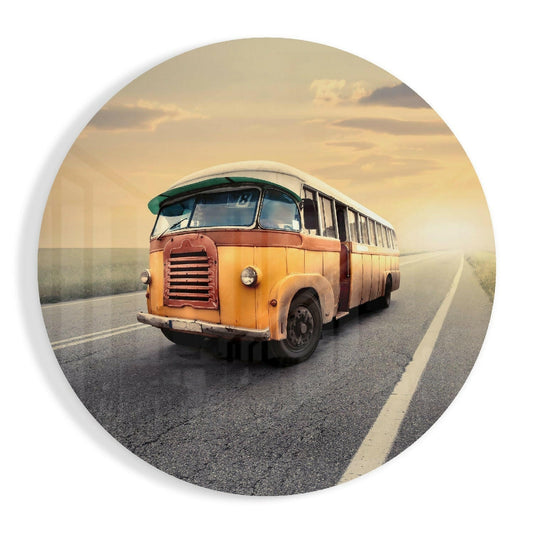 Vintage orange and cream bus traveling on a straight highway under a golden sunset sky, shown in a circular glass format.
