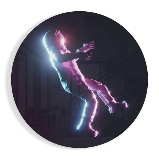 Circular glass wall art depicting a neon-glowing figure in mid-fall, illuminated in cyan blue and magenta pink against a dark background.