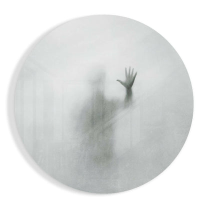 Frosted glass circular panel displaying a blurred silhouette of a person with raised arm against white background.