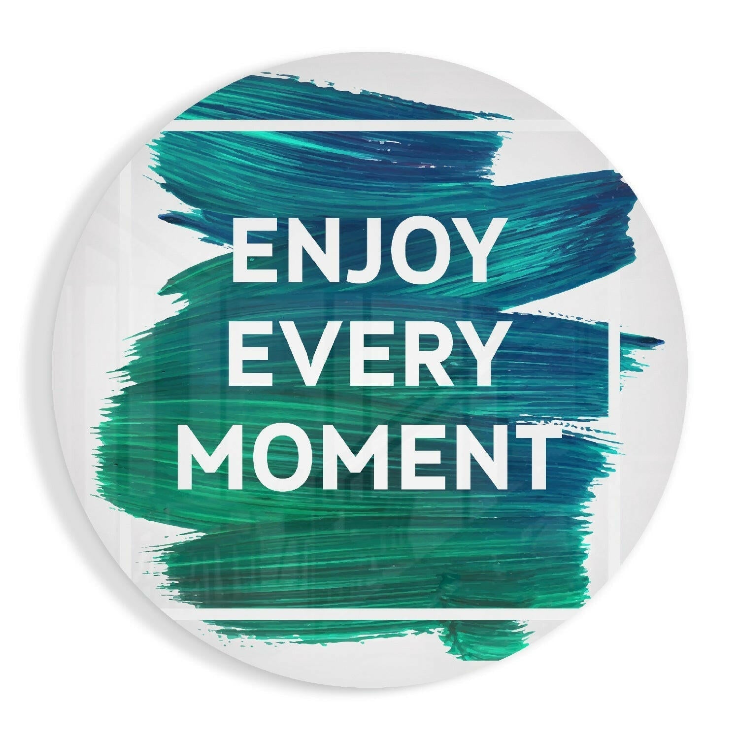 Circular glass wall art with white background and teal brushstroke design displaying "ENJOY EVERY MOMENT" in white text.