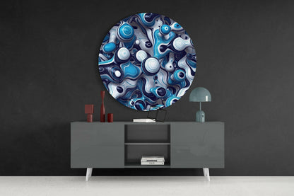 Round blue and white glass wall art with swirled patterns displayed above gray media console in modern interior setting.