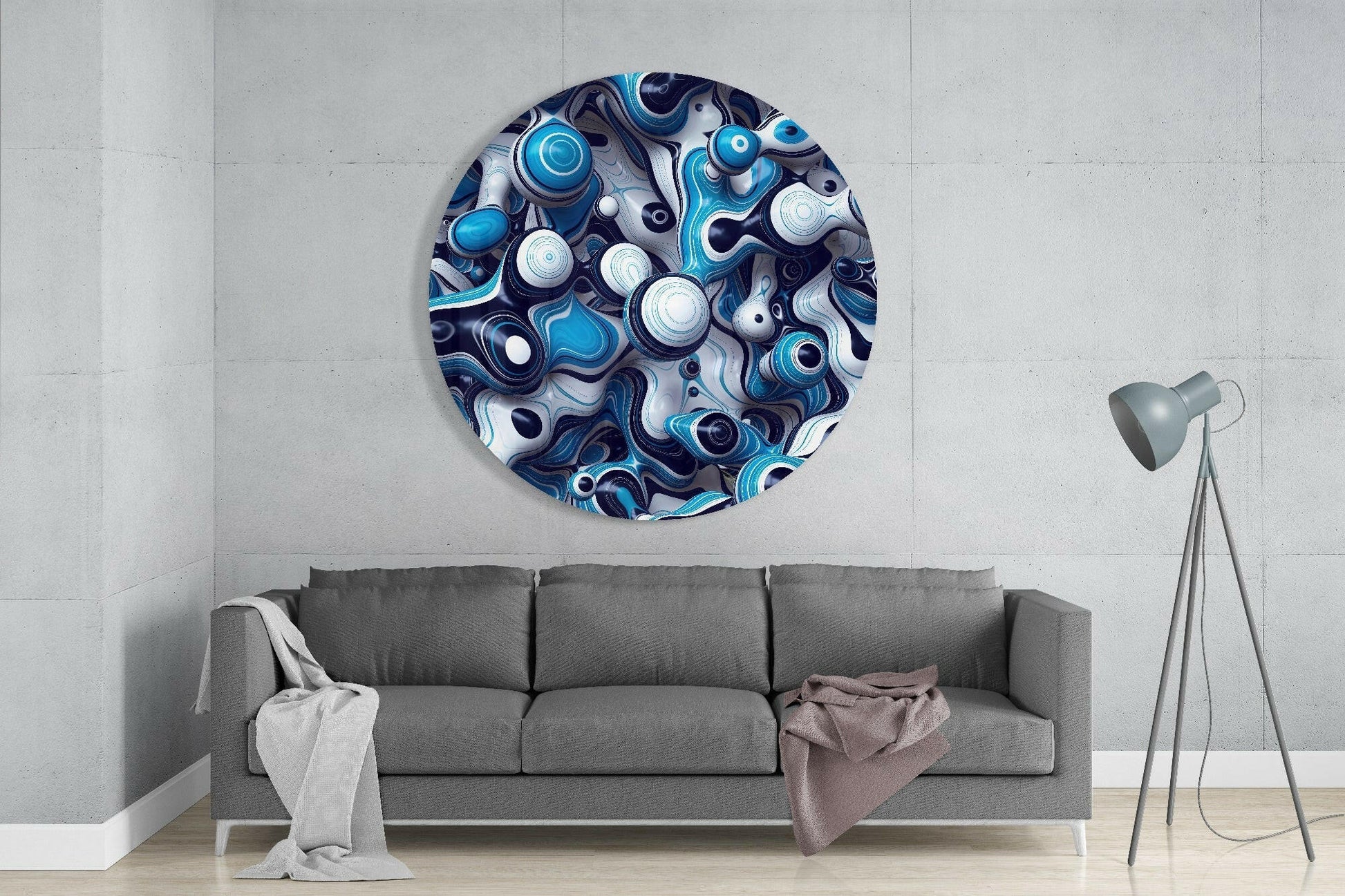 Circular blue, white, and navy glass wall art with swirling abstract patterns displayed above gray sofa in modern living room.