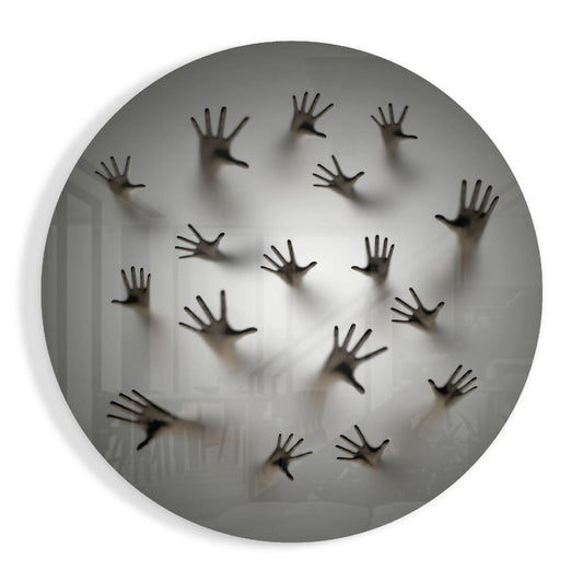 Multiple dark hands pressed against frosted circular glass panel, creating shadowy silhouettes on translucent white surface.