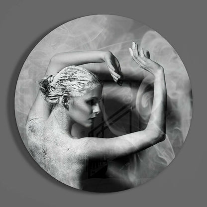 Black and white circular glass wall art depicting a woman's profile with textured hair and raised arms against a cloudy background.