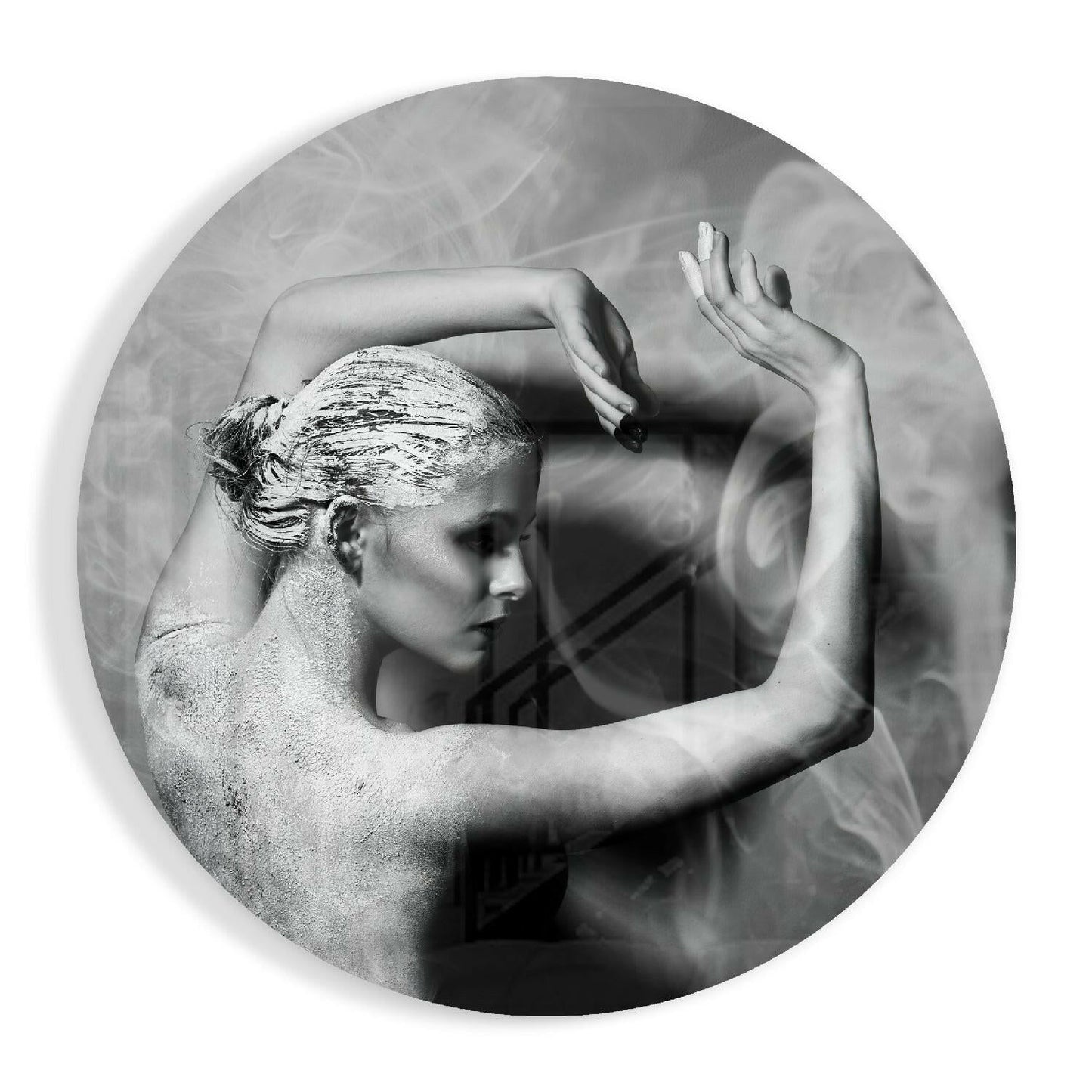 Black and white circular glass art featuring a sculptural profile of a woman with her arms raised, textured background visible through translucent center.