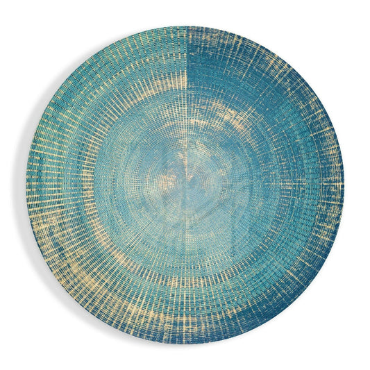 Overhead view of a circular teal and cream woven glass wall art with concentric radial pattern creating a ripple effect.
