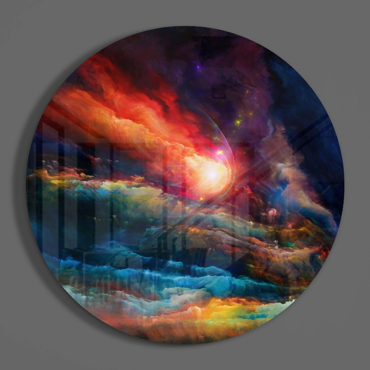 Circular glass wall art featuring a luminous cosmic explosion with vibrant red, orange, yellow, blue, and purple hues against a gray background.