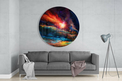 Circular glass wall art depicting a cosmic landscape with red, orange, blue, and purple nebula clouds, mounted above a gray sofa in a minimalist interior.