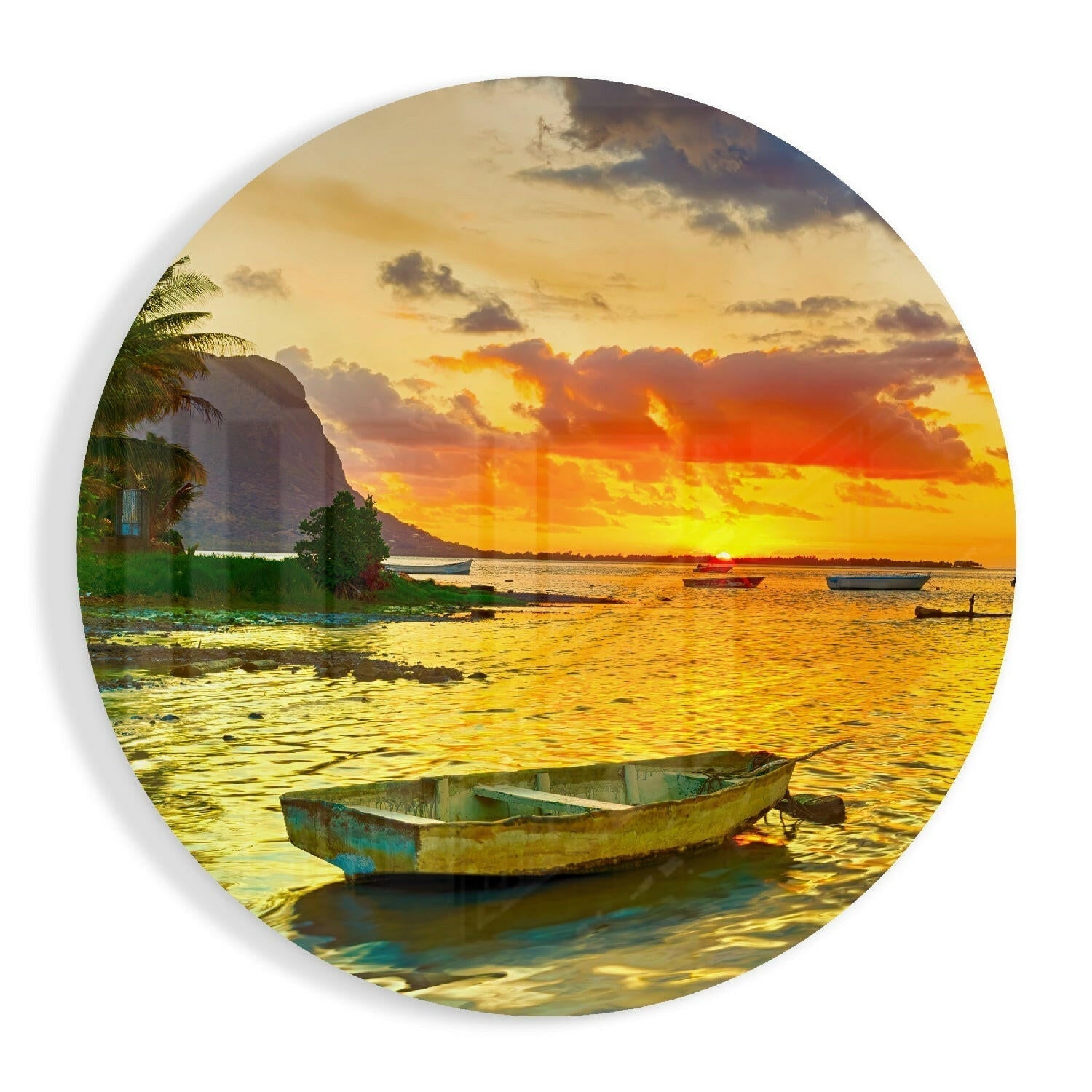 Weathered blue and yellow rowboat floating in shallow golden water at sunset with palm trees and mountain backdrop on circular glass art.