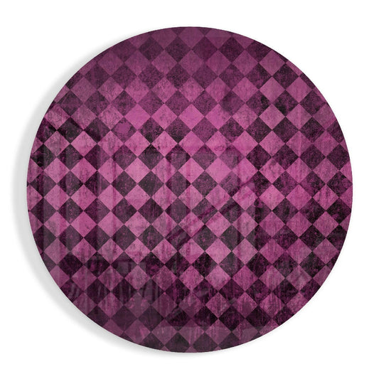 Circular pink and dark purple distressed glass wall art with diagonal diamond checker pattern, photographed flat against white background.