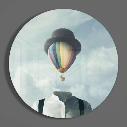 Surreal composite artwork featuring faceless figure with bowler hat and hot air balloon replacing head against cloudy sky background.