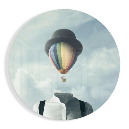 Surreal portrait with colorful hot air balloon replacing person's head against cloudy sky backdrop.