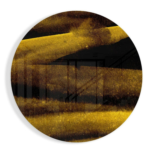 Circular glass wall art with horizontal striped layers in gold, brown, and black tones, viewed from front.