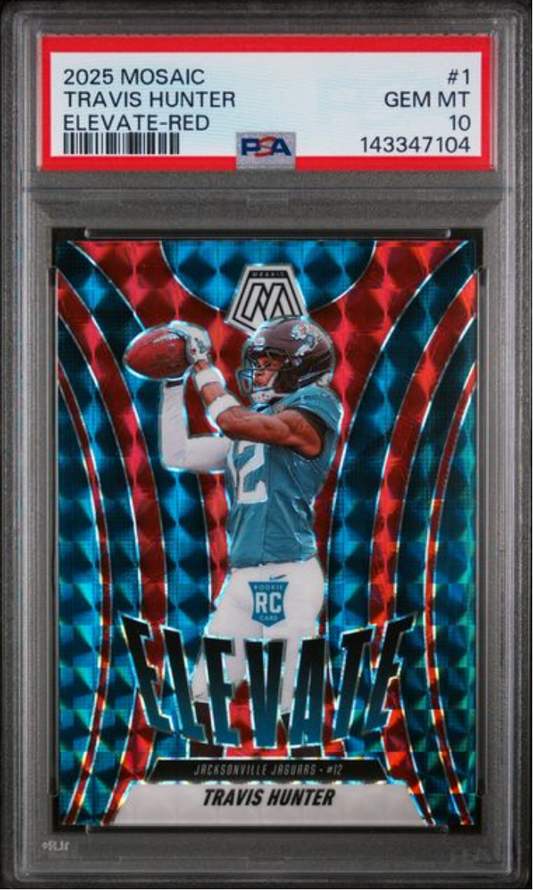 PSA-graded rookie card in clear plastic case displaying Travis Hunter in blue Jaguars uniform catching football against red and blue geometric background.