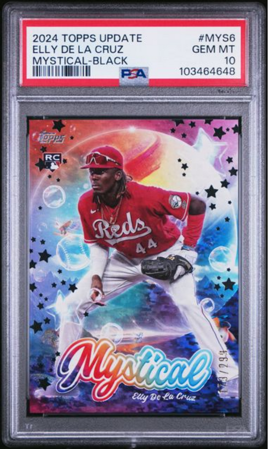 PSA-graded 2024 Topps Update Elly De La Cruz Mystical-Black baseball card in clear plastic case, showing player in red Reds uniform against colorful gradient background with stars.