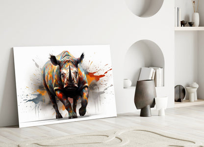Colorful rhino glass wall art leaning against white wall in minimalist interior with decorative objects and shelving.