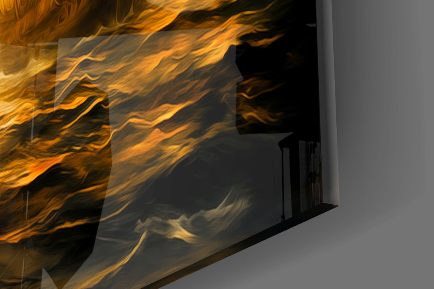 Navy in Flames glass wall art installed on gray wall, showing orange and golden liquid-like patterns with dark swirls viewed at angle.