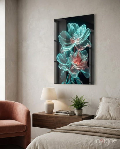 Glowing neon turquoise and coral flowers on black glass panel displayed above wooden bedside table in modern bedroom.