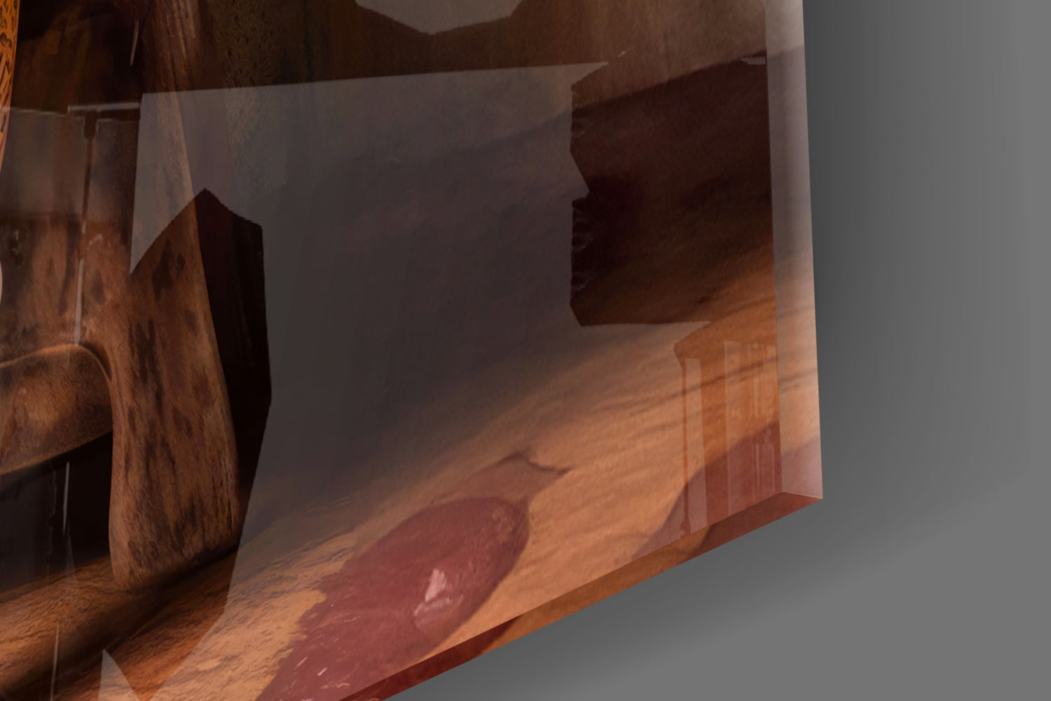 Glass wall art panel with warm amber and brown tones displayed at an angle, showing wood grain texture and translucent overlay effect.