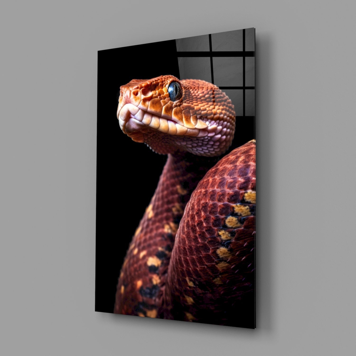 Angled product display of glass wall art featuring a red and orange viper with blue eye against black background.