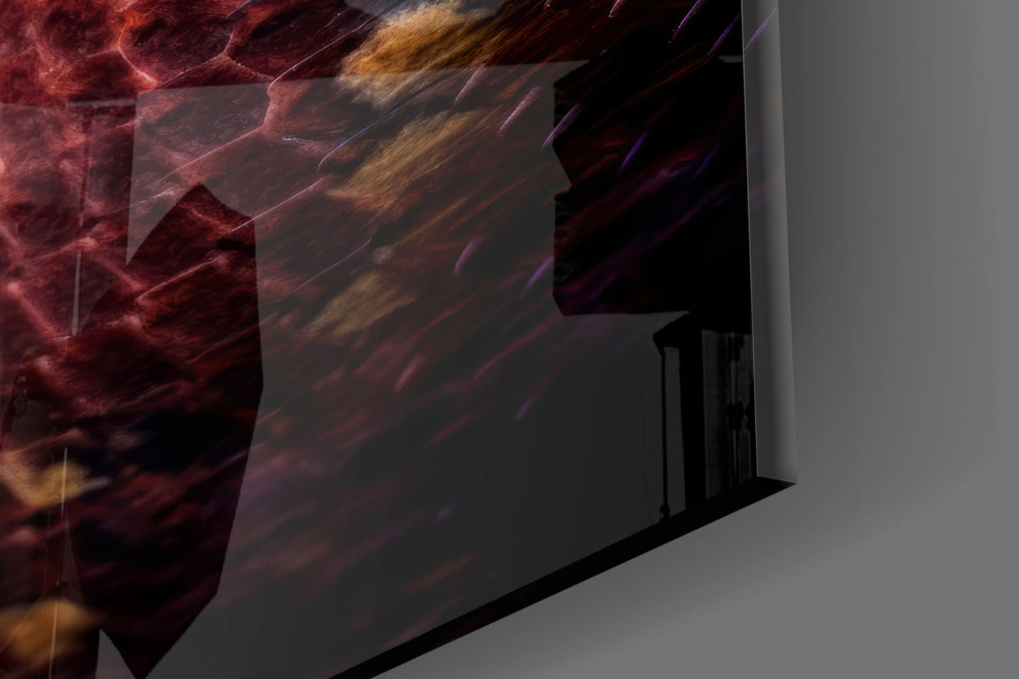 Red Stare Viper glass wall art displayed at an angle, showing deep red and gold abstract imagery with diagonal striations on a gray background.